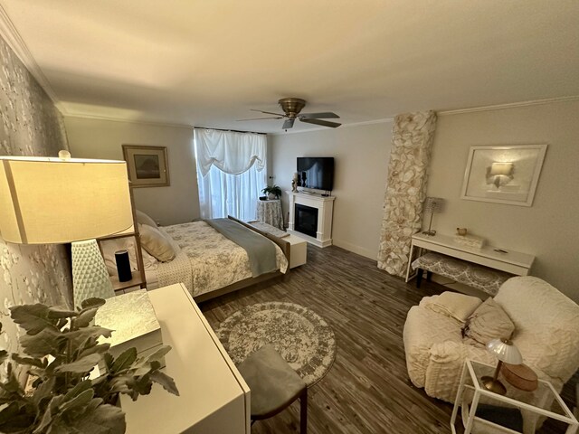 bedroom with dark hardwood / wood-style floors, ceiling fan, and ornamental molding