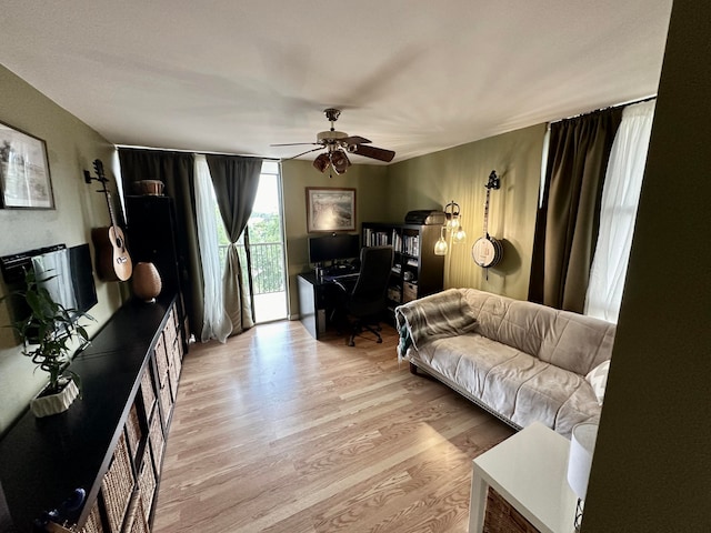 living room with ceiling fan and light hardwood / wood-style floors