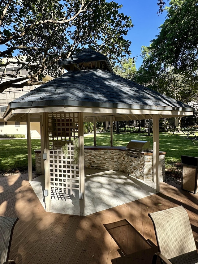 view of home's community featuring a gazebo, an outdoor kitchen, a deck, and a yard