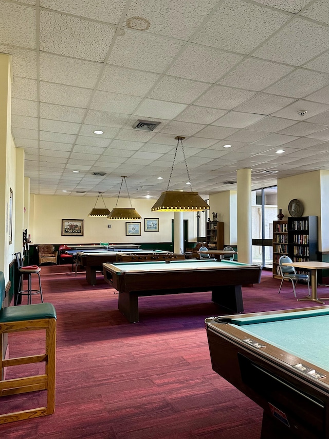 rec room with a paneled ceiling, hardwood / wood-style flooring, and pool table