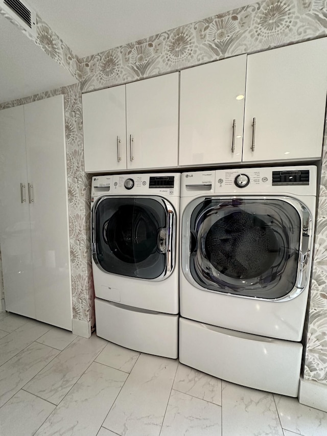 2816 N 46th Ave Unit J682, Hollywood, FL 33021 - washroom featuring cabinet space, separate washer and dryer, light marble finish flooring, and wallpapered walls