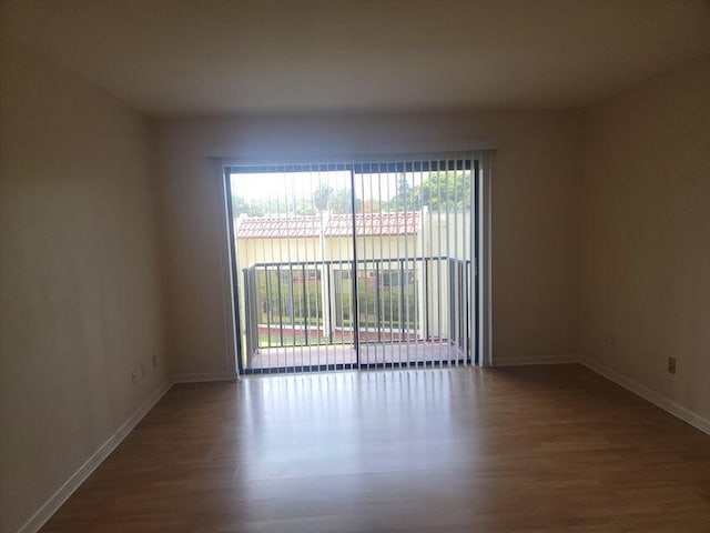 empty room with hardwood / wood-style flooring