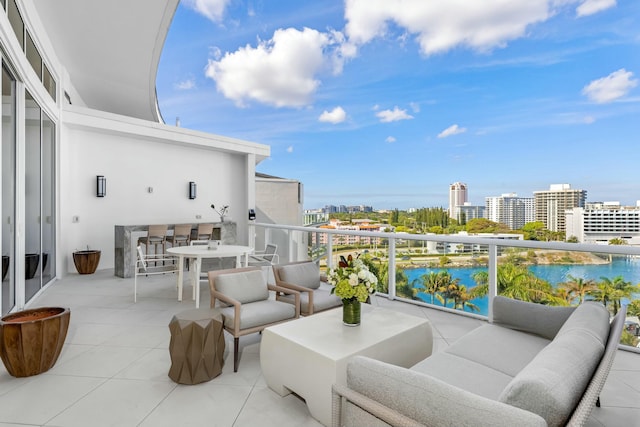 balcony featuring a water view and an outdoor hangout area