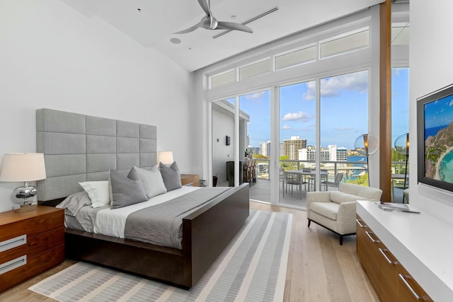 bedroom featuring access to exterior and light hardwood / wood-style floors