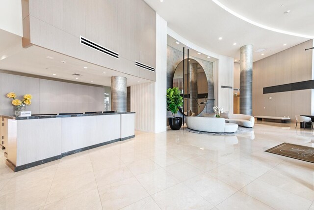 workout area featuring a towering ceiling and wood-type flooring