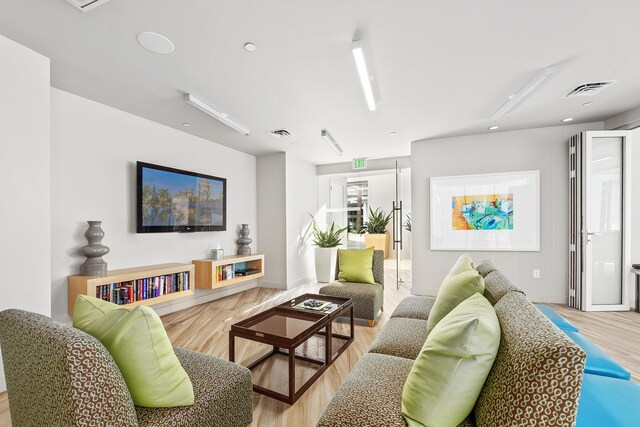 living room featuring a towering ceiling and a wealth of natural light