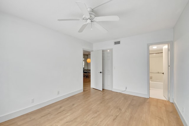 unfurnished bedroom with light wood-type flooring, ceiling fan, and connected bathroom