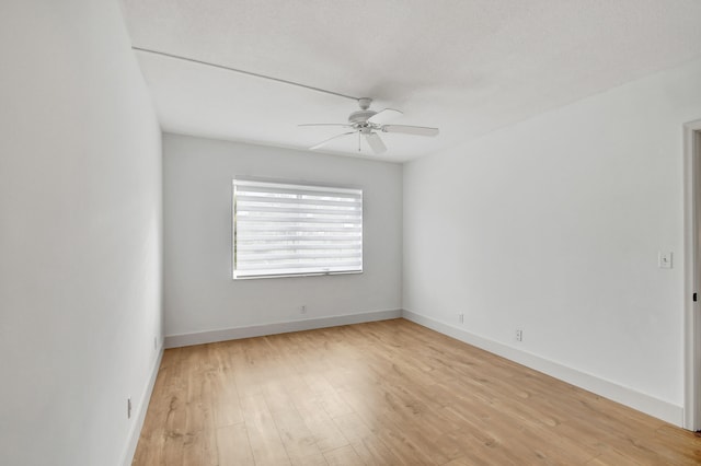 unfurnished room with ceiling fan and light hardwood / wood-style flooring