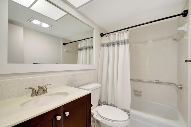 full bathroom with shower / bathtub combination with curtain, vanity, tile walls, and toilet