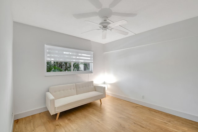 living area with light hardwood / wood-style floors and ceiling fan