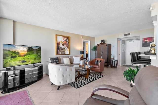 living room with light tile patterned floors and a textured ceiling