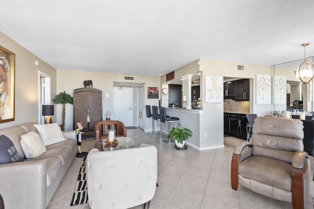 899 Jeffery St Unit 604, Boca Raton, FL 33487 - living room with a textured ceiling and light tile patterned floors