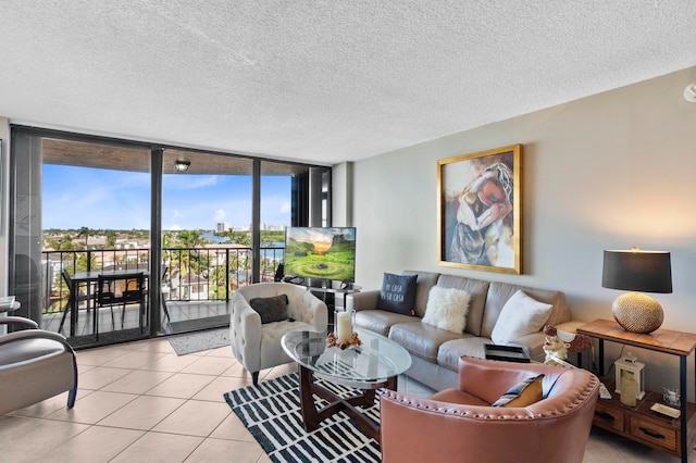 tiled living room featuring floor to ceiling windows and a textured ceiling