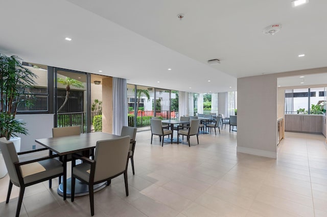 tiled dining room with expansive windows