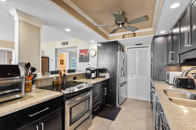 kitchen with sink, light tile patterned floors, crown molding, stainless steel appliances, and light stone counters