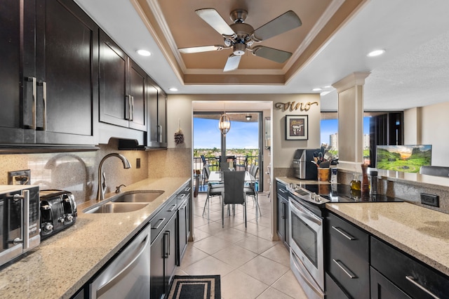 kitchen featuring stainless steel dishwasher, ornamental molding, a tray ceiling, sink, and electric range