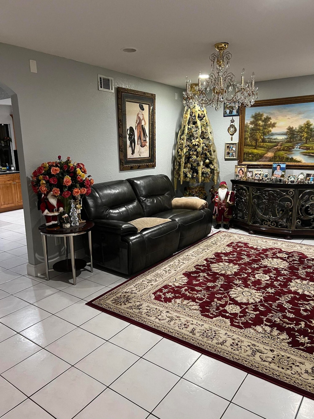 living room featuring a chandelier and light tile patterned floors