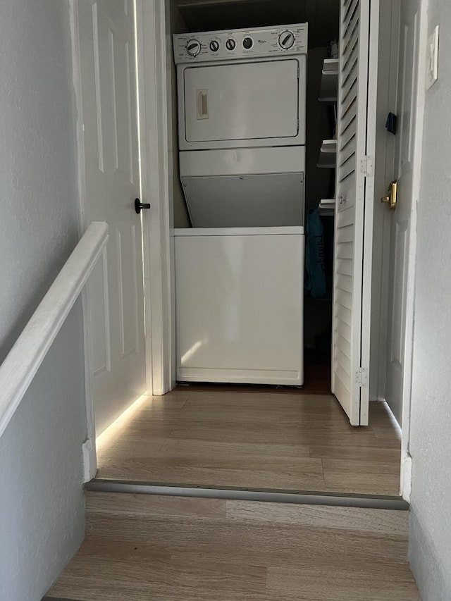 20 Laredo Pl Unit 2-1, Davie, FL 33324 - laundry room with estacked washer and dryer, wood finished floors, and a textured wall