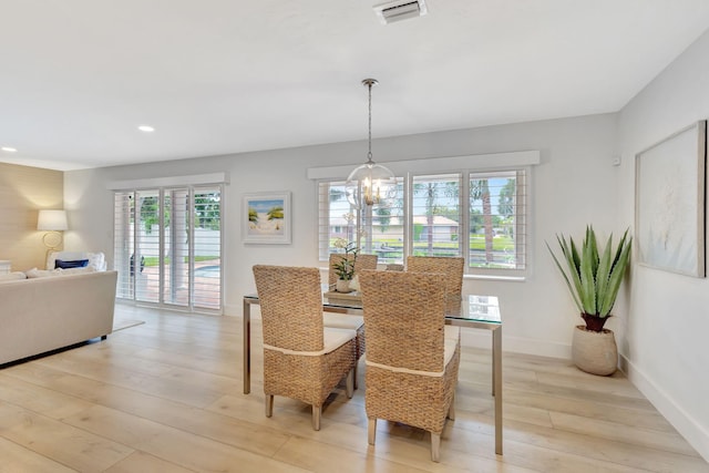 dining area featuring a chandelier and light hardwood / wood-style flooring