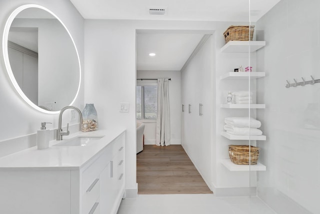 bathroom featuring hardwood / wood-style floors and vanity