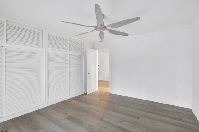 unfurnished bedroom featuring a closet, ceiling fan, and light hardwood / wood-style flooring