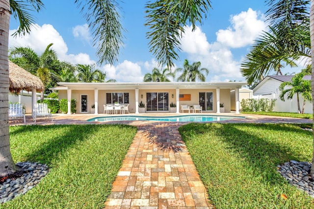 view of pool featuring a yard and a patio