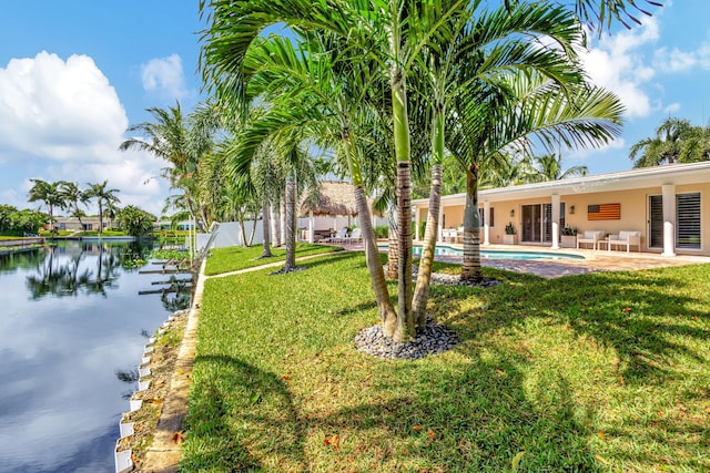 view of yard with a water view and a patio