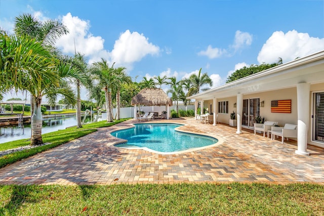 view of pool featuring a water view and a patio area