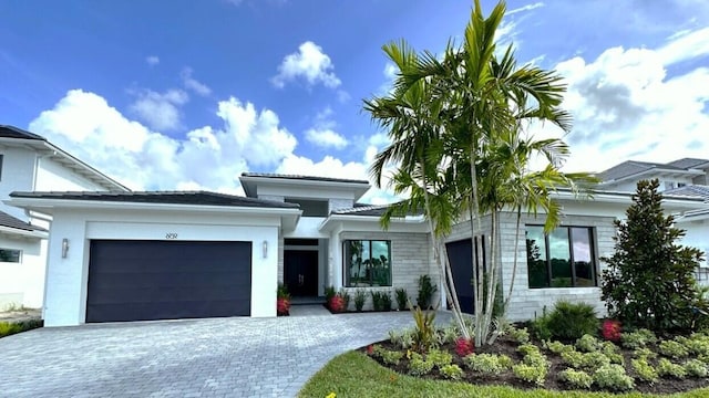 view of front facade with decorative driveway and an attached garage