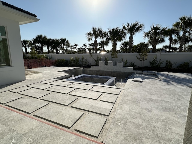 view of swimming pool with an in ground hot tub, a patio area, and a fenced backyard