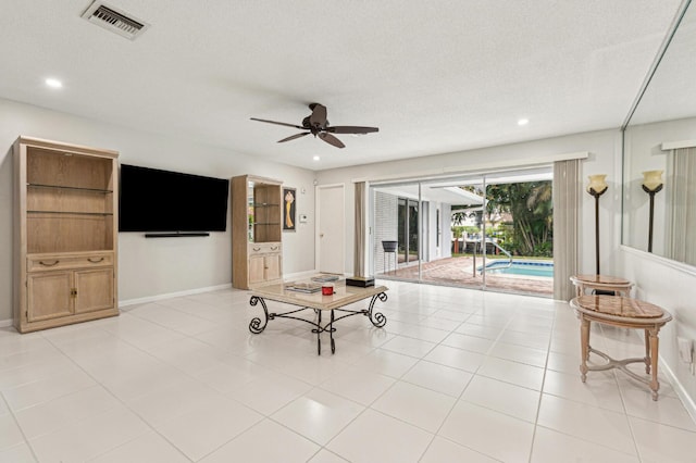 playroom featuring ceiling fan, a swimming pool, light tile patterned flooring, and a textured ceiling