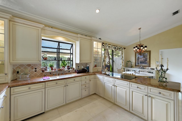 kitchen featuring cream cabinetry, kitchen peninsula, and sink