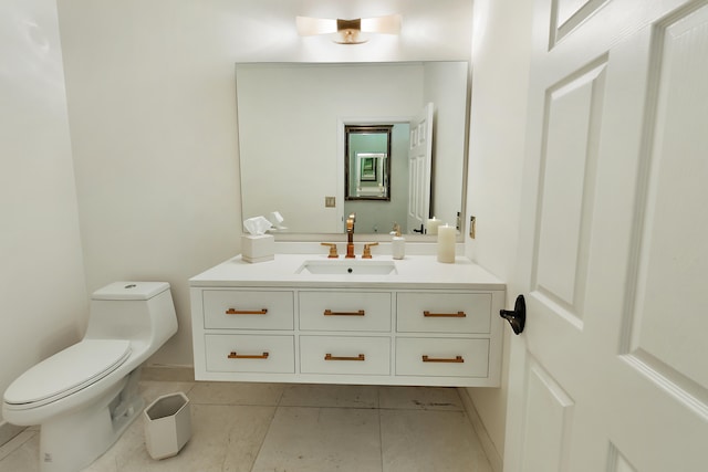 bathroom featuring tile patterned flooring, vanity, and toilet