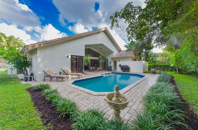 view of pool with a patio and grilling area