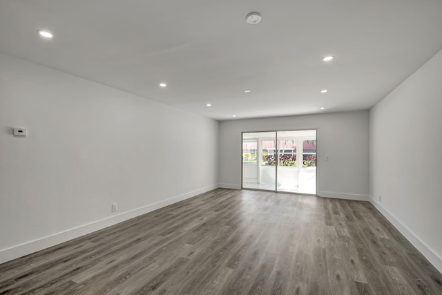 spare room with dark wood-type flooring