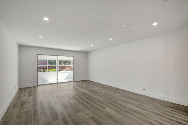 empty room with dark hardwood / wood-style flooring