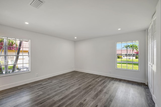 empty room with dark wood-type flooring