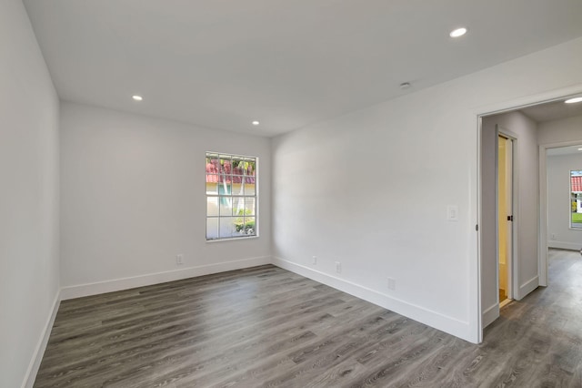 spare room featuring dark wood-type flooring