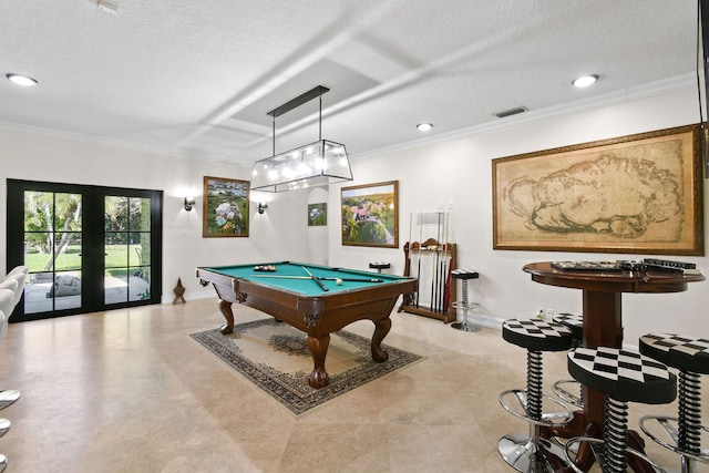 recreation room featuring pool table, french doors, ornamental molding, and a textured ceiling