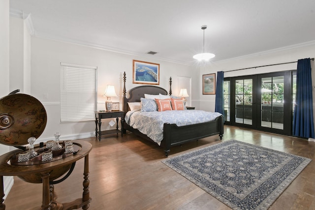 bedroom with access to exterior, wood-type flooring, french doors, and crown molding