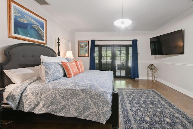 bedroom featuring hardwood / wood-style flooring, french doors, and ornamental molding