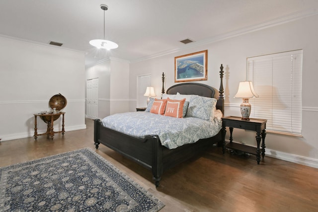 bedroom featuring a closet, crown molding, and dark hardwood / wood-style floors