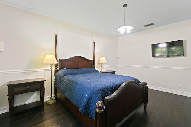 bedroom featuring dark hardwood / wood-style flooring and ornamental molding