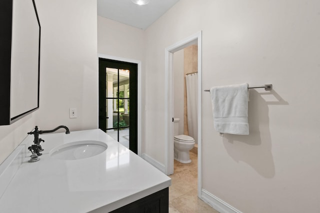 bathroom featuring a shower with shower curtain, tile patterned floors, vanity, and toilet