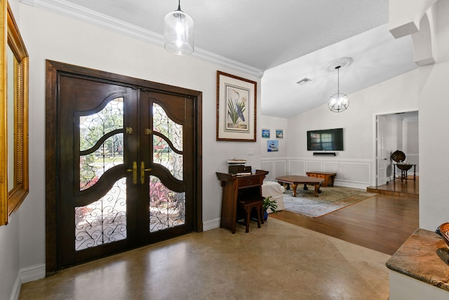 entryway featuring ornamental molding, vaulted ceiling, a textured ceiling, an inviting chandelier, and french doors