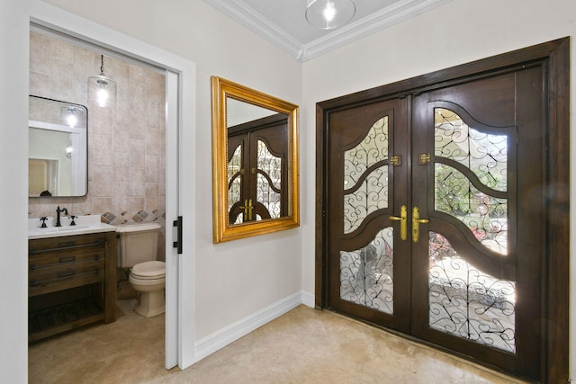 interior space with french doors, ornamental molding, and sink