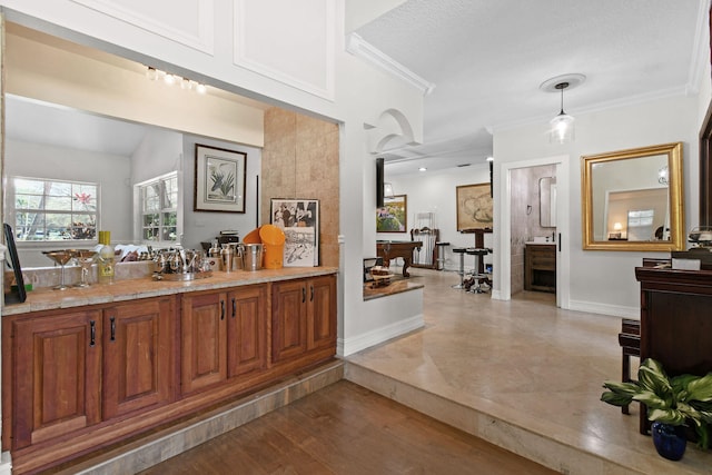 bathroom featuring vaulted ceiling, ornamental molding, hardwood / wood-style floors, and a textured ceiling