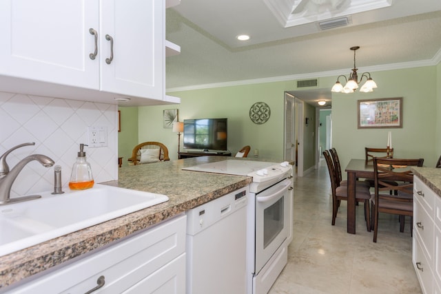 kitchen with pendant lighting, white appliances, white cabinets, sink, and ornamental molding