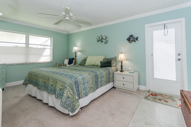 carpeted bedroom with ceiling fan and ornamental molding