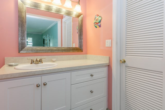 bathroom with vanity and crown molding